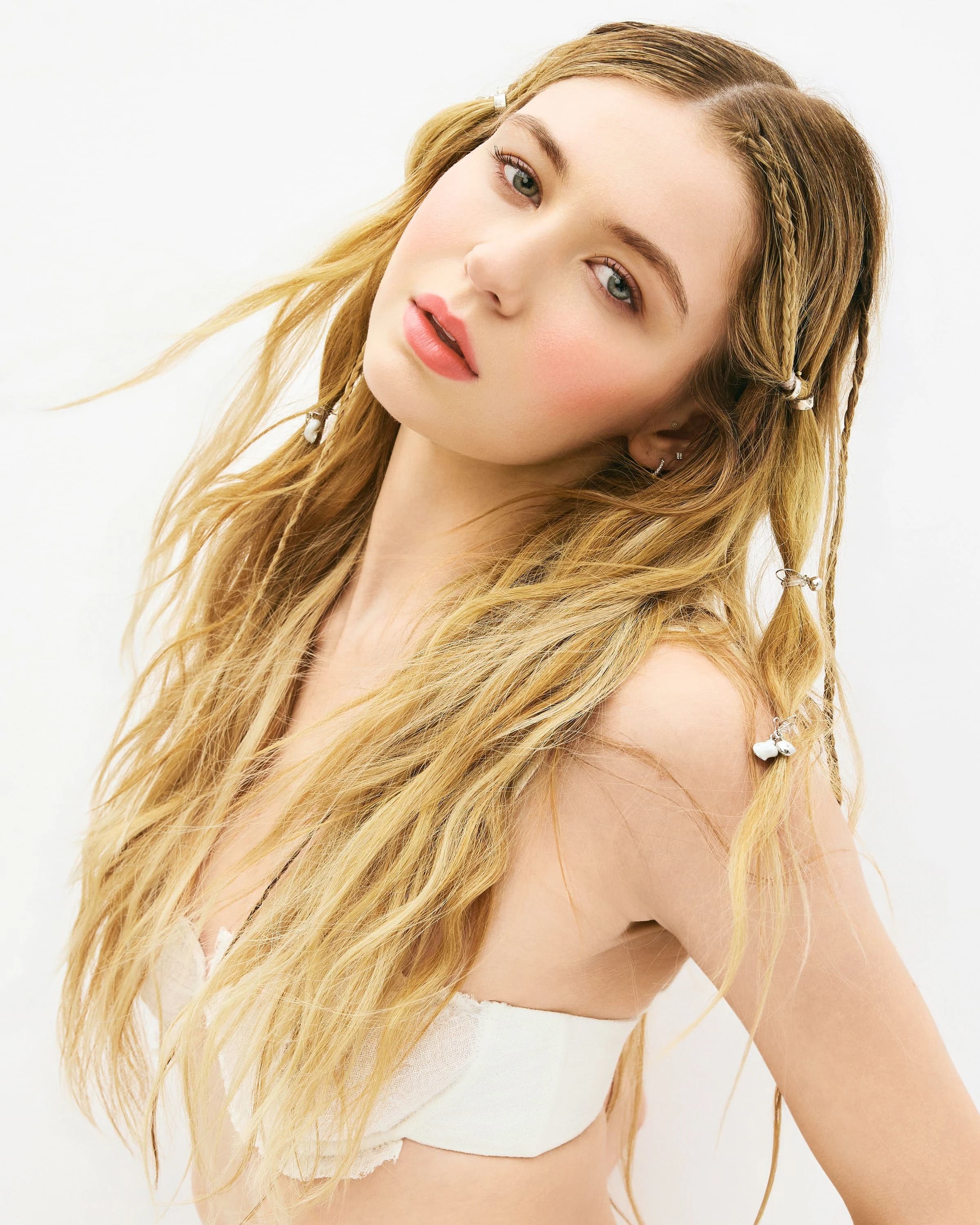Three-quarter portrait of Sage Burress against a white background with loose blonde hair.