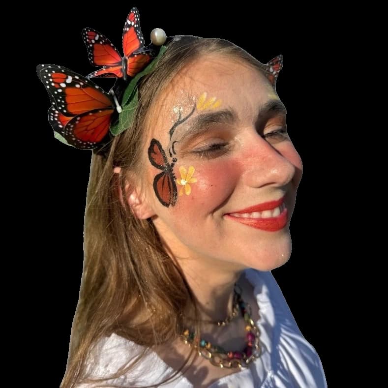Butterfly face painting with orange wings and delicate floral details.