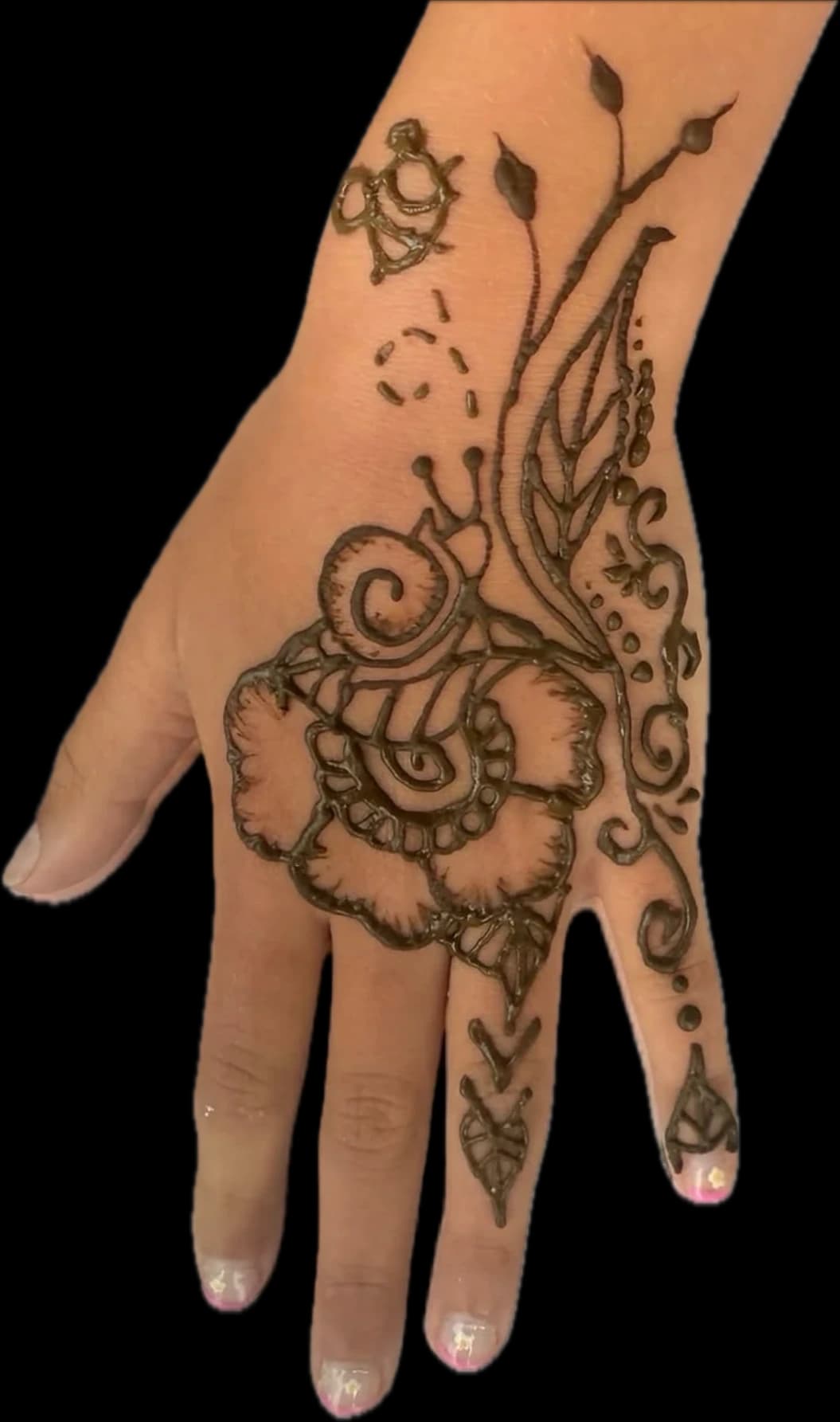 Detailed floral henna design extending across a hand and wrist.