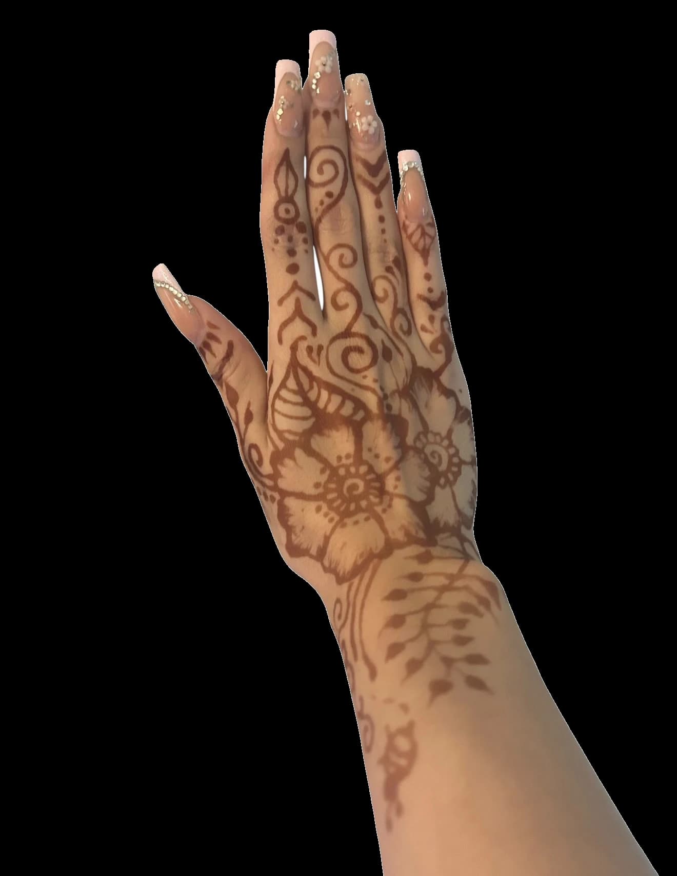 Dense floral henna design extending from fingertips to the wrist.
